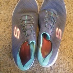 Pink and blue sketchers shoes